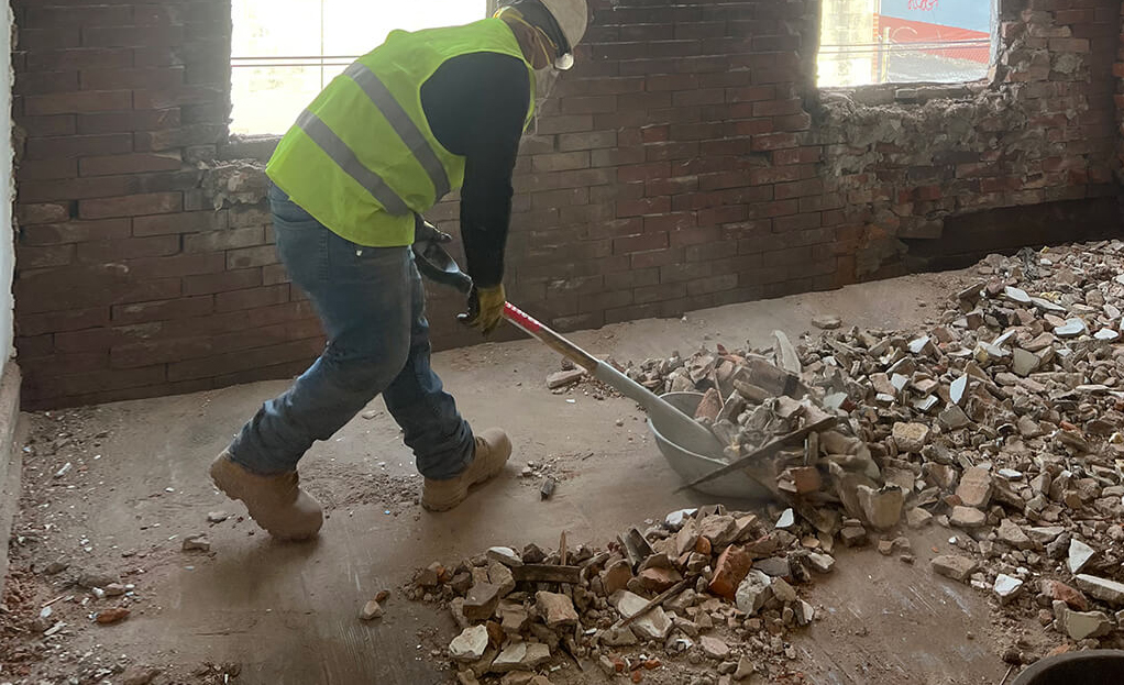 worker moving debris during a property clean out in Philadelphia